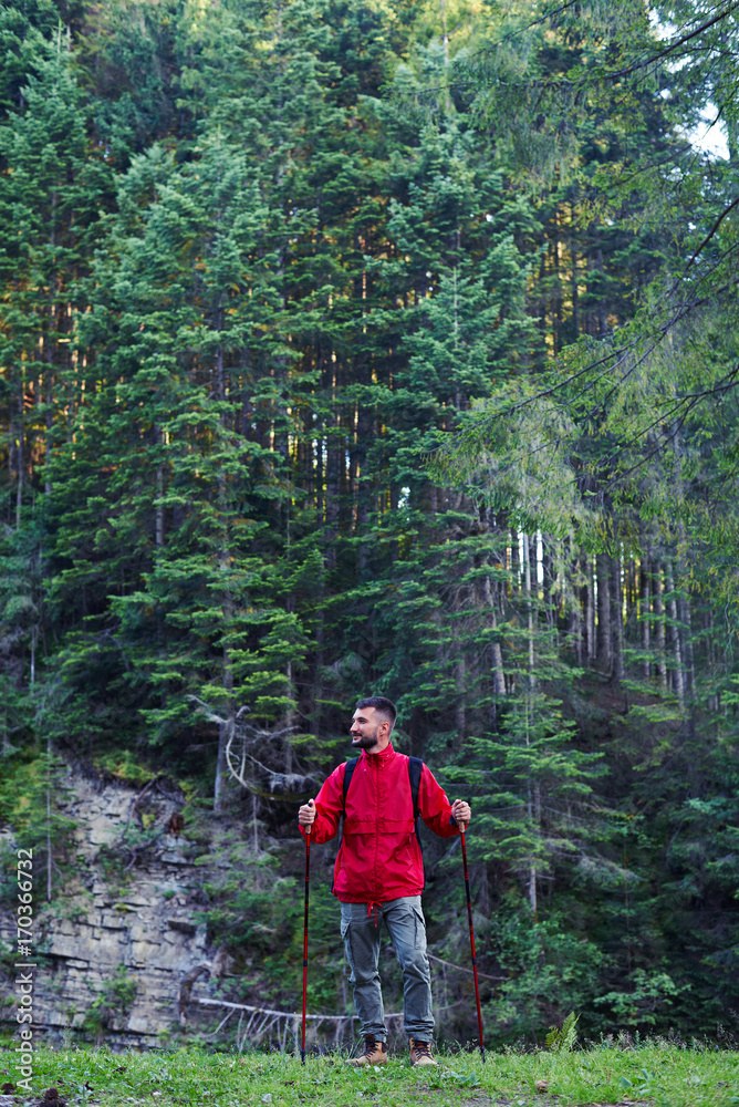 Man with hiking poles looking sidewards