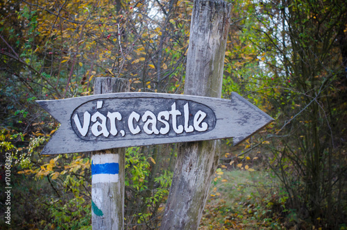 Wooden sign to the castle in Hungary in autumn park photo