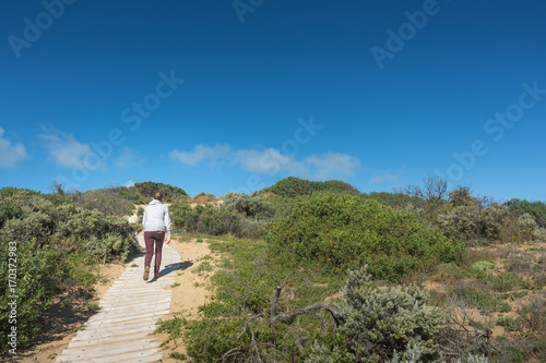 Fototapeta Naklejka Na Ścianę i Meble -  Woman hiking over sand dune in Coorong National Park
