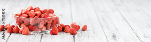 Portion of Strawberries (dried) on wooden background, selective focus