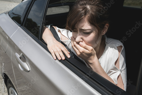 young woman getting carsickness.