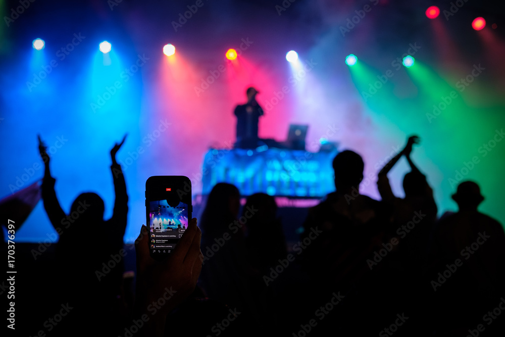 A night concert with lights as seen through a cell phone screen