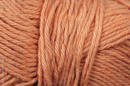 A super close up image of orange yarn