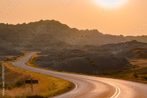 Scenic road at sunset in Badlands National Park.