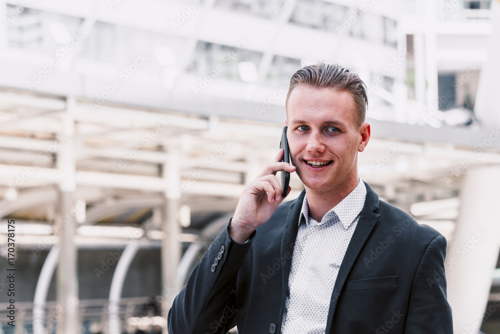 Handsome businessman using his smartphone Handsome businessman using his smartphone