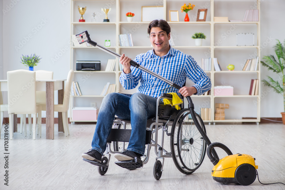 Disabled man cleaning home with vacuum cleaner Disabled man cleaning home with vacuum cleaner
