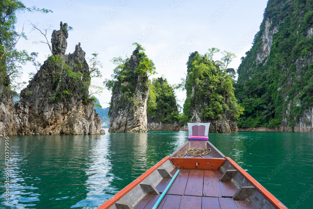 Fototapeta premium Boat tail to sail see scenic and unique landscape with floating houses and long tail boats at Chieou Laan lake, Thailand