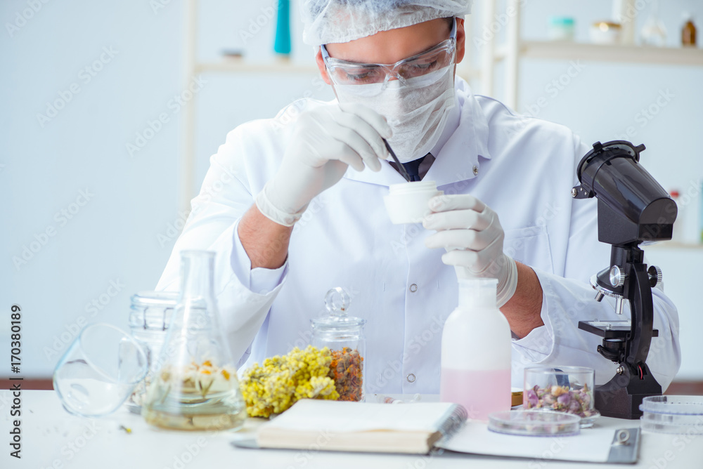 Chemist mixing perfumes in the lab Chemist mixing perfumes in the lab