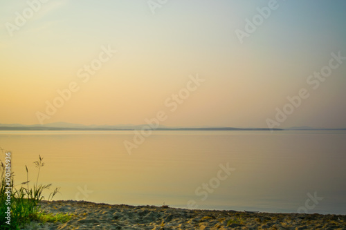 Obraz na płótnie Golden sunset at a shore of a lake with silhouette of plants, Uveldy, the Ural, Russia w salonie