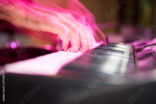 Musician plays keyboards in a rock band