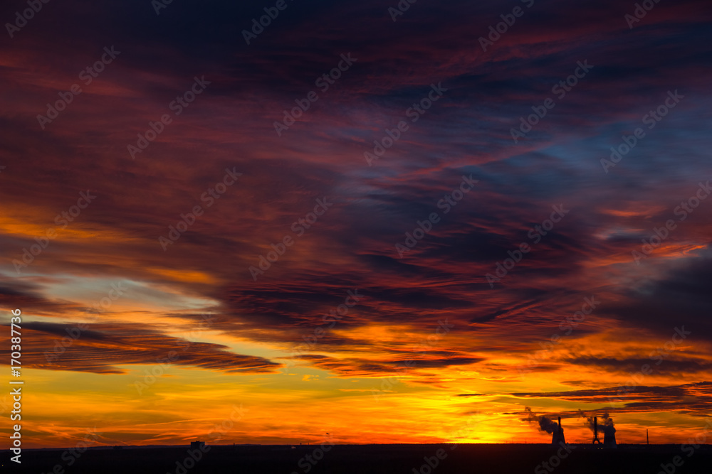 the smoke from the chimney at sunset. Colorful dramatic sunset in industrial zone of city. Silhouettes of houses and chimneys with smoke. Copy space the smoke from the chimney at sunset. Colorful dramatic sunset in industrial zone of city. Silhouettes of houses and chimneys with smoke. Copy space