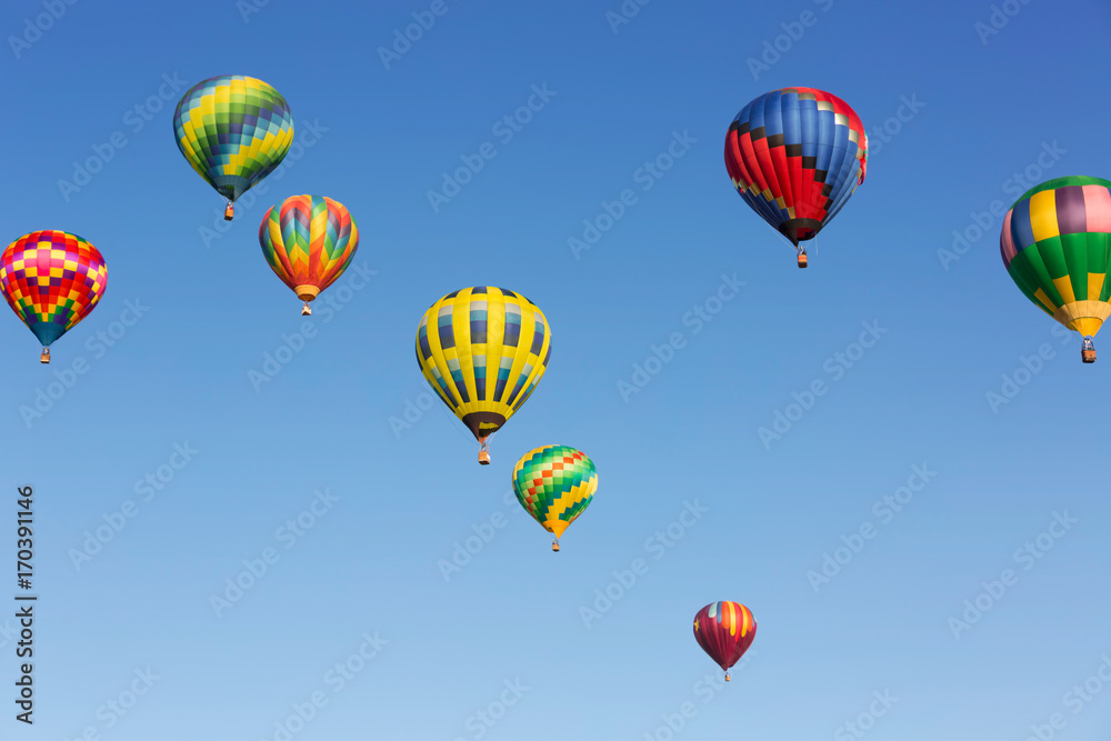 Hot air balloons up in the blue sky