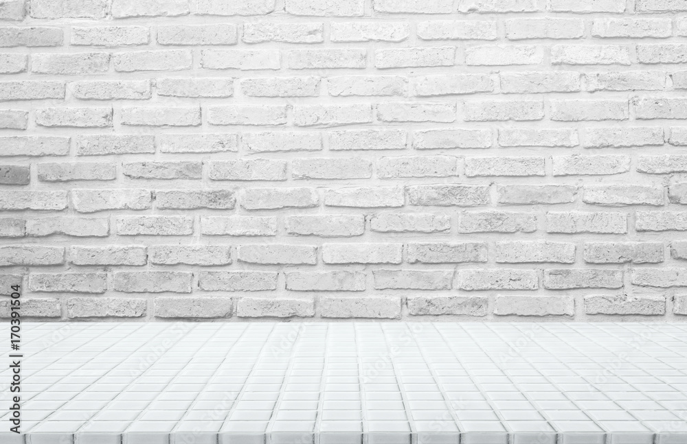 White ceramic mosaic table top and background of grey brick wall - can used for display or montage your products.