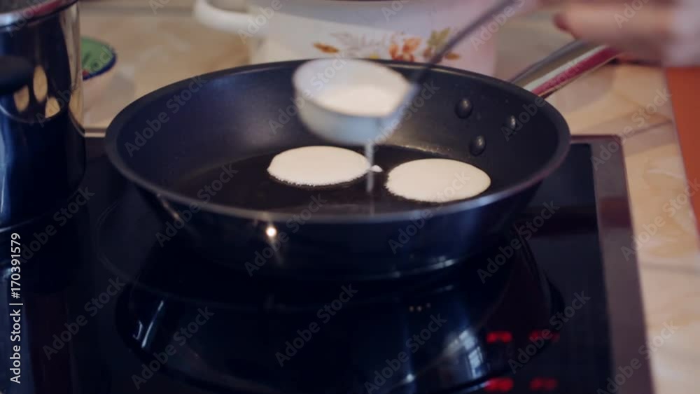 Frying sweet thick pancakes on a pan Frying sweet thick pancakes on a pan