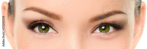 Green eyes Asian woman eyelashes makeup banner. Closeup of almond chinese eyes and eyebrows, with eyeshadow make-up and false eyelashes