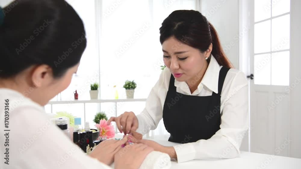 chinese manicurist is applying nail file chinese manicurist is applying nail file