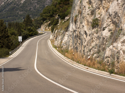 Empty asphalt road with solid white stripe