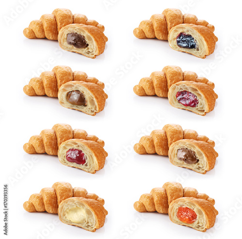 Fotografering Sliced croissant with chocolate, jam, condensed milk and cream isolated on white background