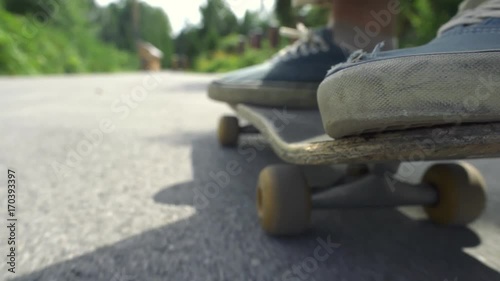 close-up Skater boy ride on skateboard in skate park outdoor.Orange skate foot wear shoes,skate board deck.Skateboarding is popular sport for young active people.Extreme skate boarding sport in photo
