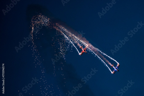 Two planes on the sky during the night airshow. photo