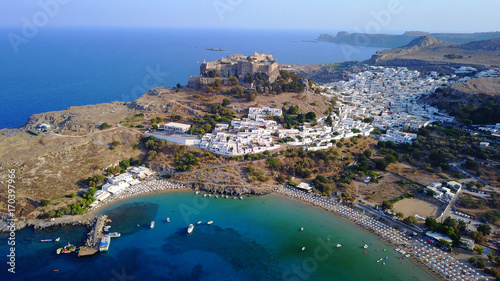 Fototapeta Naklejka Na Ścianę i Meble -  Aerial drone photo of famous beach of Lindos with turquoise waters and iconic ancient Acropolis - village of Lindos, Rodos island, Aegean, Dodecanese, Greece