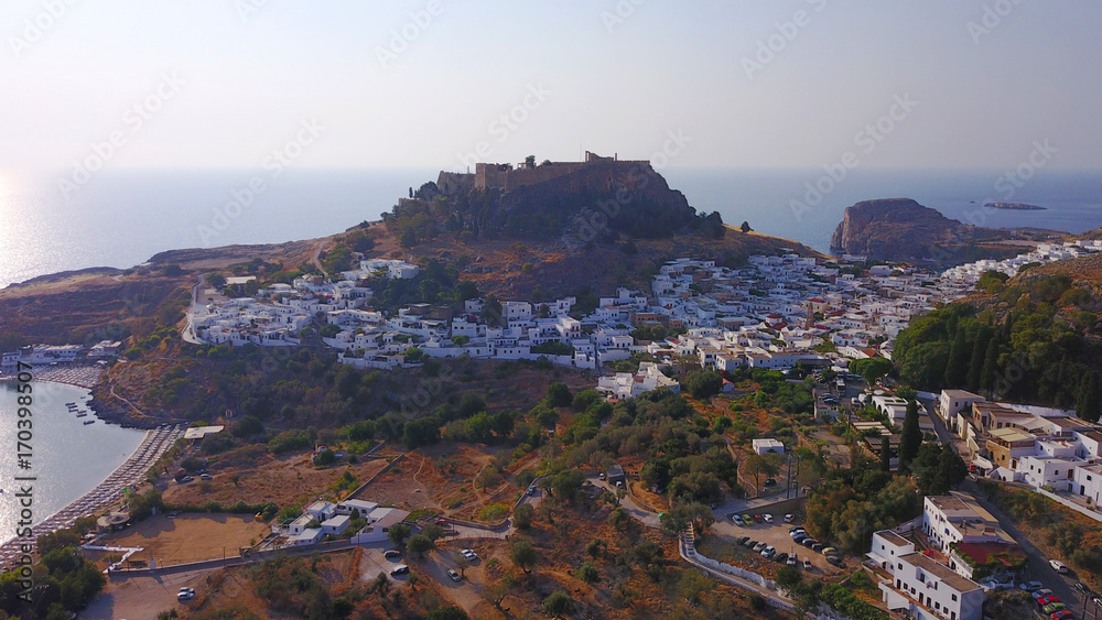 Aerial drone photo of iconic ancient Acropolis and village of Lindos, Rodos island, Aegean, Dodecanese, Greece