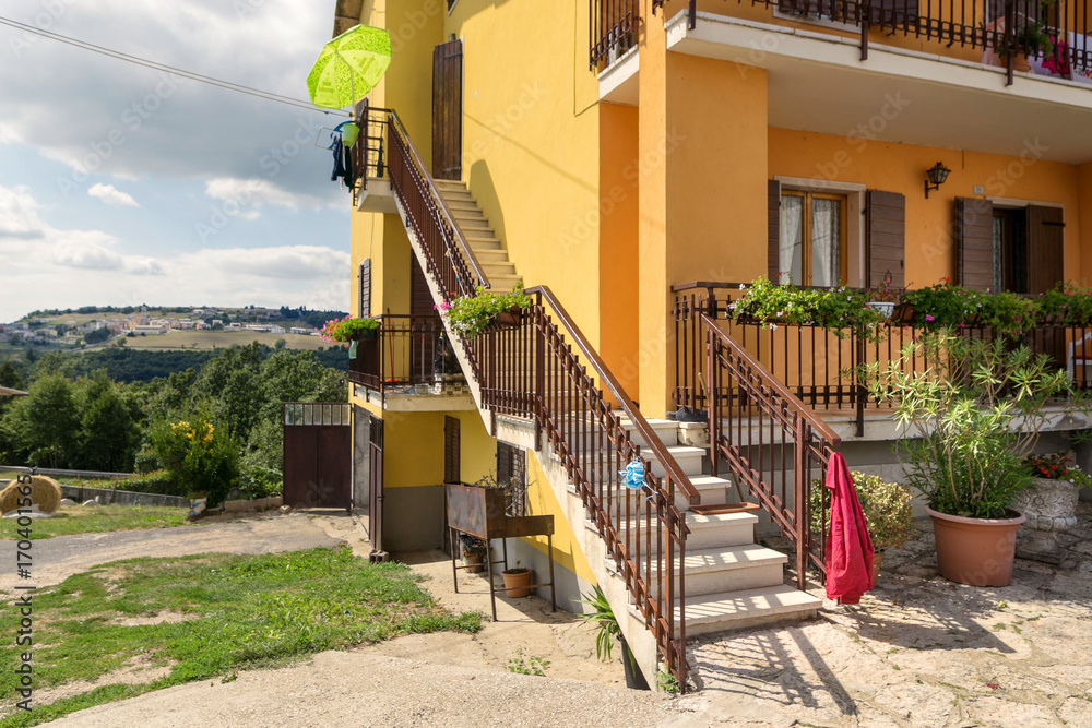 Cescatto, Italy - August 22, 2017: House with patio from the mountain village of Italy. Cescatto, Italy - August 22, 2017: House with patio from the mountain village of Italy.