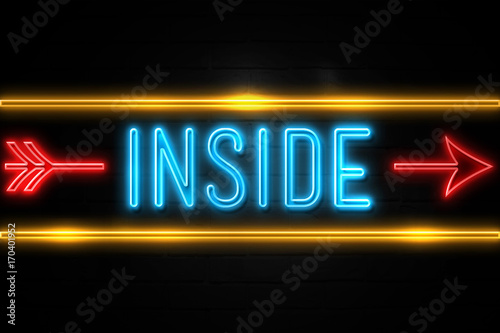 Inside - fluorescent Neon Sign on brickwall Front view