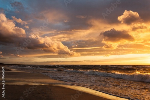 Sunset with clouds and waves at the Baltic Bay, Latvia © photoannalaine