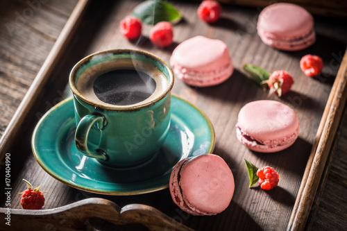 Sweet pink macaroons served with hot coffee