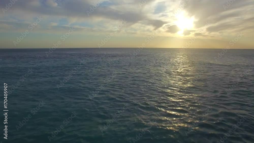 Aerial Shot of Flying over Ocean at Sunset