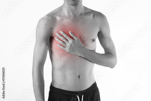 Young man chest pain or heart attack on white background.