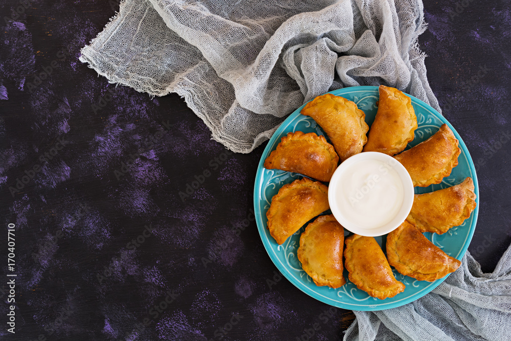 Baked dumplings on dark background. Top view Baked dumplings on dark background. Top view