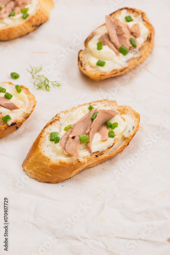 Bruschetta. Sandwich tuna fish salad on wooden background