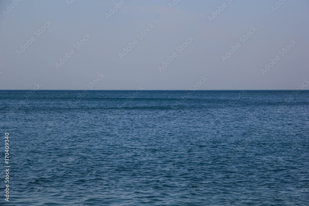 Calm Blue sea waves soft surface Ocean And Blue Sky Background