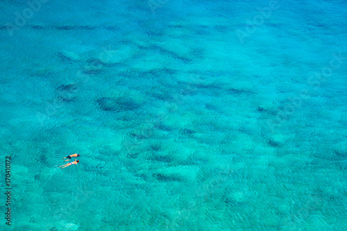 Above view of couple snorkeling in turquoise sea water, Glyka Nera, Chania, Crete, Greece