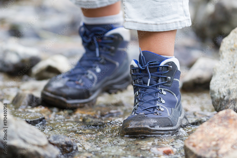 Woman hiking through a waterfall - selective focus