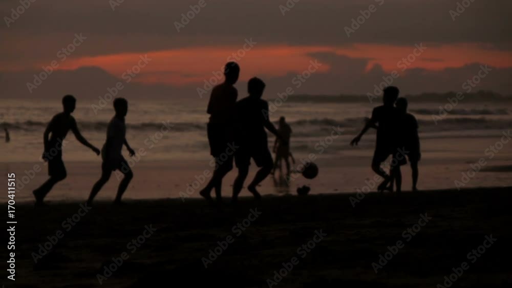 Group of teenagers playing football on beach during sunset, super slow motion 240fps
Group of teenagers playing football on beach during sunset, super slow motion 240fps