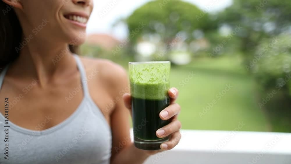Green Juice - Happy Young Woman Holding Glass Of Fresh Vegetable Juice. Close up of green smoothie. Green Juice - Happy Young Woman Holding Glass Of Fresh Vegetable Juice. Close up of green smoothie.