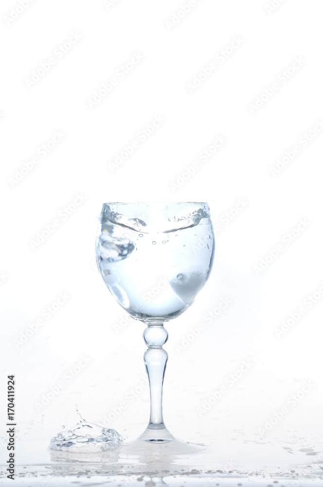 cool water, Ice cubes splashing into glass of water, water splashing from ice cubes being dropped in a glass. cool water, Ice cubes splashing into glass of water, water splashing from ice cubes being dropped in a glass.