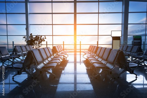 Empty seats in the departure lounge at the airport in the sunset