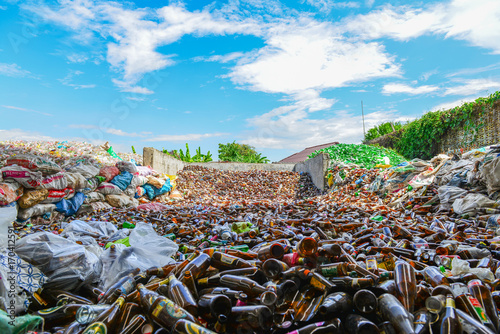 Glass bottles in recycling centre.Particles of crushed shattered glass at a recycling facility photo