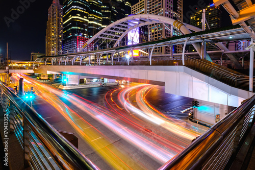 Sky walker at the center connected to electric train station colorful in night bangkok city