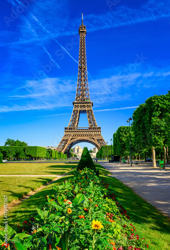Paris Eiffel Tower and Champ de Mars in Paris, France. Eiffel Tower is one of the most iconic landmarks in Paris. The Champ de Mars is a large public park in Paris. © Ekaterina Belova