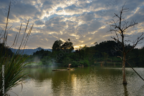 Local fisher man use fish net catch fish in lake in Hoa Binh province, Vietnam photo