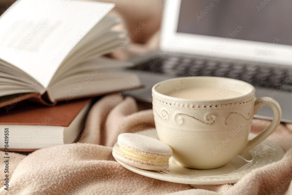 Cup of tea with autumn leaves reflection on book on wooden table. Season of Education Cup of tea with autumn leaves reflection on book on wooden table. Season of Education