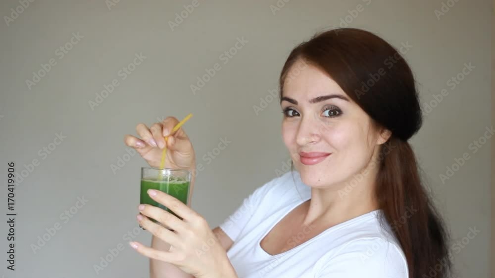 Vegetable detox cleanse smoothie. Girl smilling and drinking green juice. Diet and healthy lifestyle. Vegetable detox cleanse smoothie. Girl smilling and drinking green juice. Diet and healthy lifestyle.