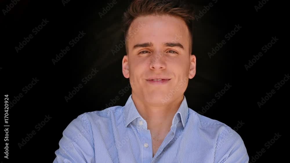 Portrait of a young man with a black background. Close up Portrait of a young man with a black background. Close up