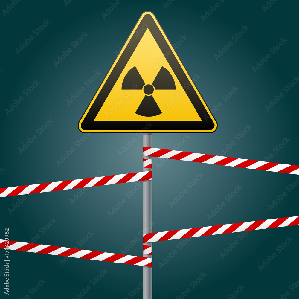 Warning sign on a pole and warning bands. Sign of radiation hazards ...