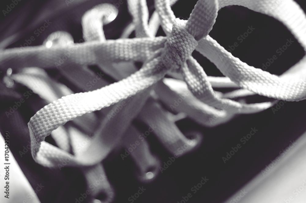 white shoelace tie on black sneakers shoe SELECTIVE FOCUS white shoelace tie on black sneakers shoe SELECTIVE FOCUS